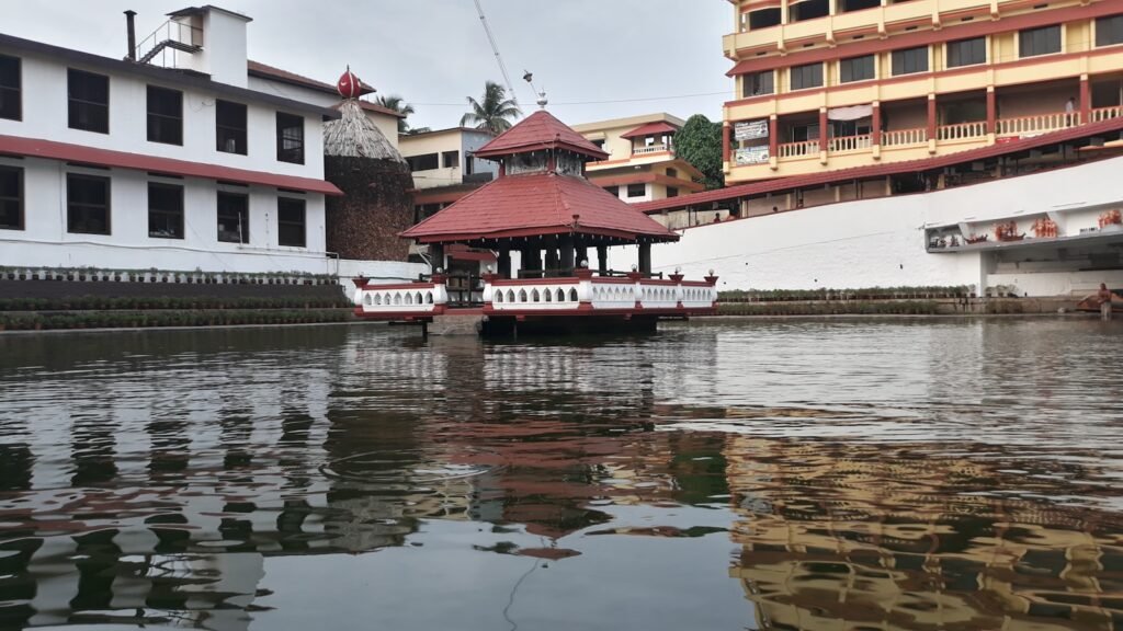 red and white concrete building near body of water during daytime
