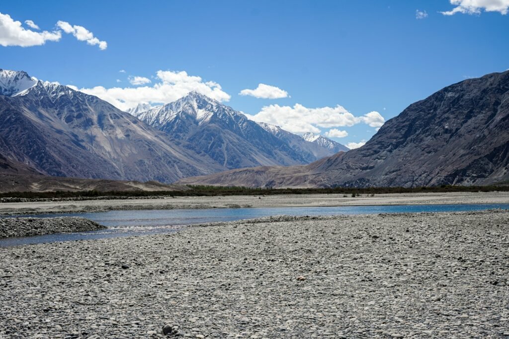A mountain range with a body of water in the foreground