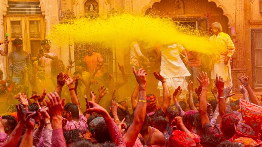 People celebrating holi with yellow powder